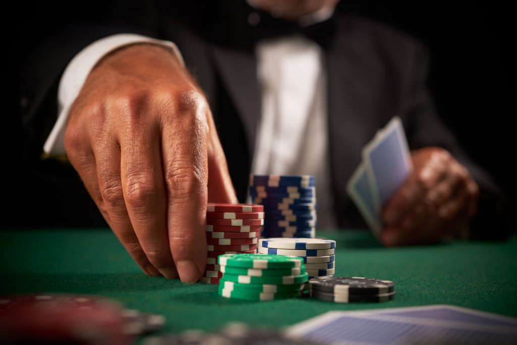card player gambling casino chips on green felt background 